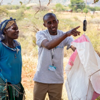 /media/pula-client-in-kenya-participating-in-harvest-measurement-process-with-pula-agent-2.jpg